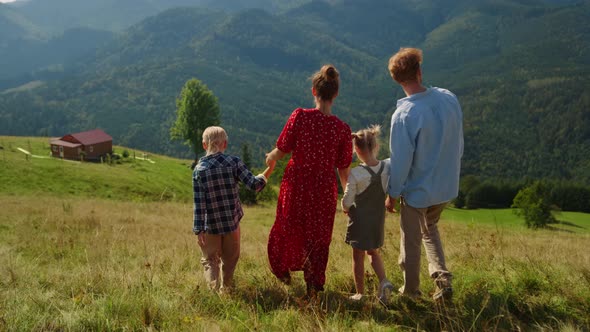 Family Coming Down Hill Enjoying Summer