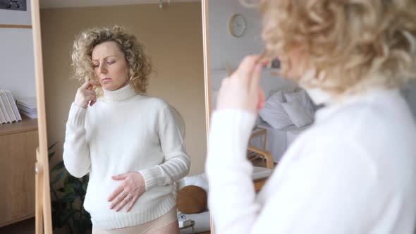 Upset Pregnant Woman Looking In Mirror Having Hair Problems During Pregnancy