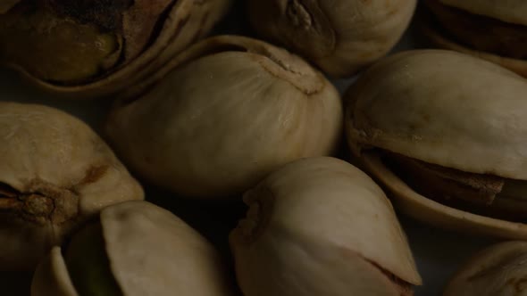 Cinematic, rotating shot of pistachios on a white surface - PISTACHIOS 010