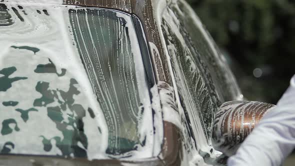 Luxury Car Covered in Soap, Male Hand Washing It with Sponge, Carwash Service