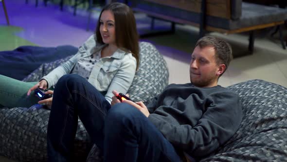 Young Couple Playing Video Game at Home