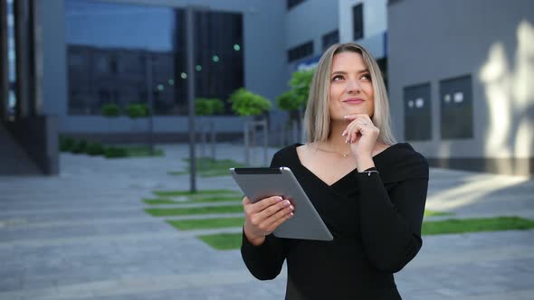 Beautiful Young Woman Using Tablet Pc in the City