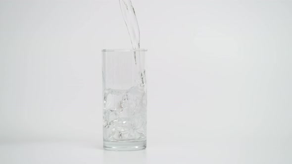 Slow Motion of Pouring Water in Glass with Ice, 1000 fps Shot