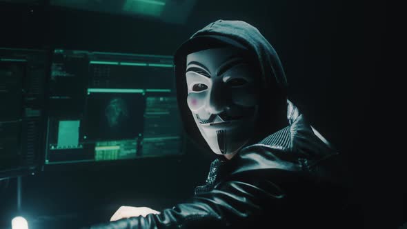 Unrecognizable Hacker Looking at Camera