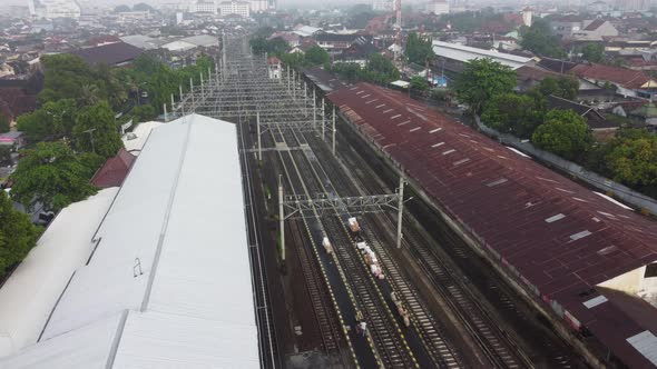 A drone flies over a train station. Aerial top view. A lot of wagons at a railway. Flying over railw