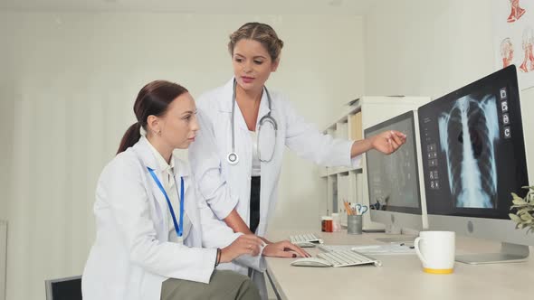 Female Doctors Discussing Chest X-Ray on Computer