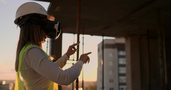 Female Engineer in Hardhat with VR Glasses Designing Construction Project at Manufacturing Plant