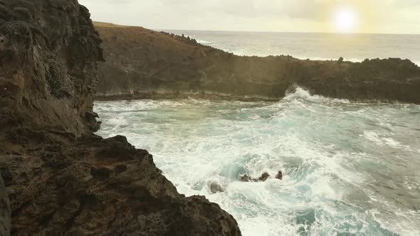 The Rocky Coast of Easter Island at Sunset, in Ana Kai Tangata Sea Cave.