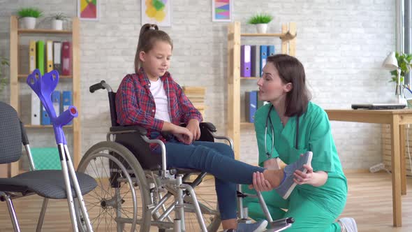 Teenage Girl After an Injury in a Wheelchair at the Reception of a Doctor