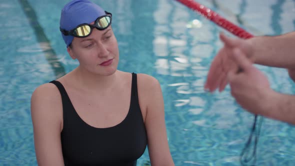 Coach Giving Advice to Female Swimmer