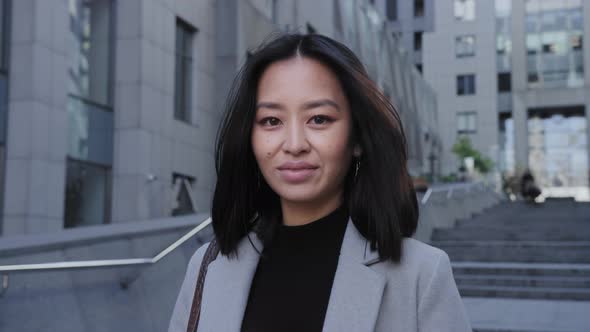 Portrait of a Young Adult Asian Woman Smiling Outdoors