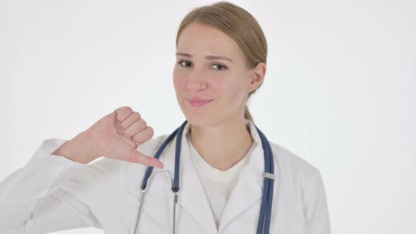 Thumbs Down Gesture By Female Doctor on White Background