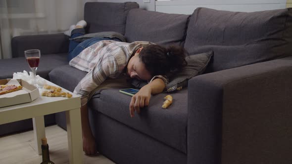 Depressed Adult Woman Lying on Couch Declining Mobile Call Indoors