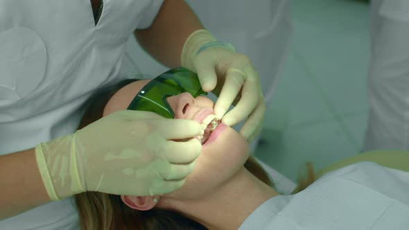 Dentist Checks Womans Teeth with Fingers