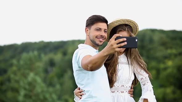 Couple Making Photo On Mobile Phone In Nature