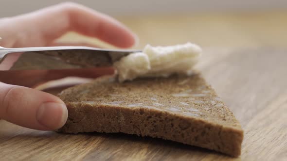 Man Cook Hands Making Toast with Hummus