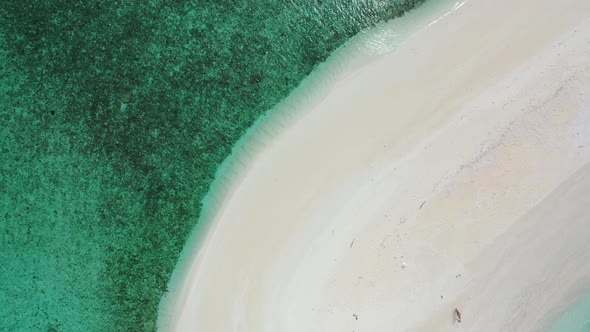 Wide overhead island view of a sunshine white sandy paradise beach and blue water background