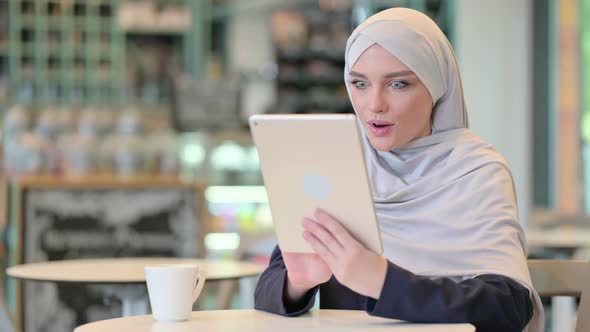 Young Successful Arab Woman with Tablet Celebrating