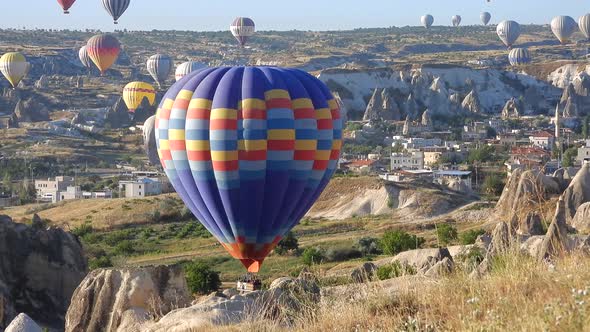 Hot Air Balloon Flying Over Hoodoos and Fairy Chimneys in Goreme Valley Cappadocia, Urgup Turkey