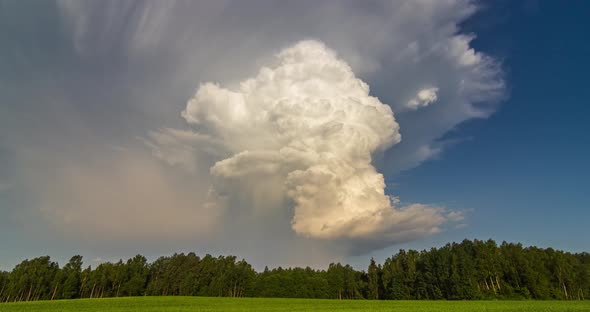 Isolated Thunderstorm White Cumulonimbus Clouds Tower Rising in the Evening Sky