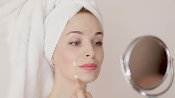 Portrait of Happy Smiling Beautiful Young Woman with White Towel on Her Head Touching Problem Skin