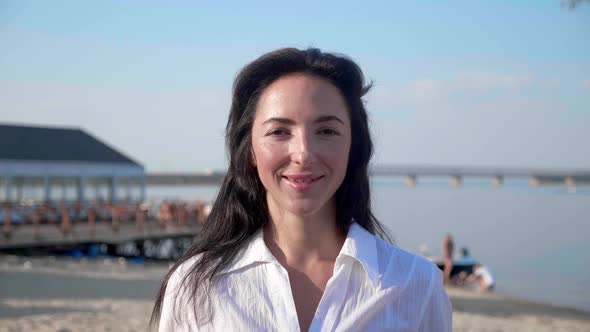 Closeup Portrait of a Brunette She Watches Flying Soap Balls Standing in Outdoor