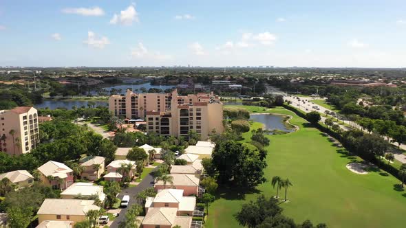 Aerial view of a neighborhood and condominiums along a golf course