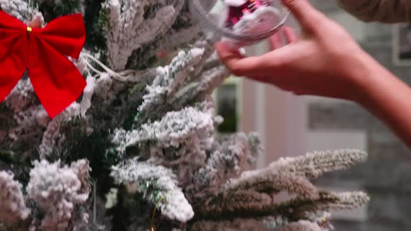 Young Woman Decorate Christmas Tree in Living Room