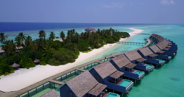 Daytime fly over abstract view of a sunshine white sandy paradise beach and turquoise sea background