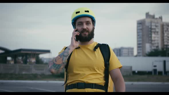 Bicycle Messenger Having a Phone Call