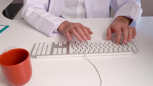 Doctor using keyboard.