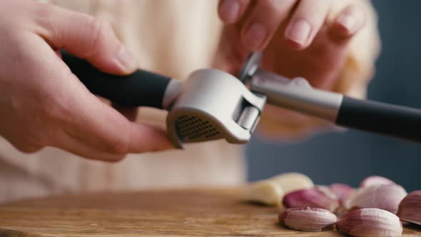 Close up of garlic clove and garlic press. Shot with RED helium camera in 4K.