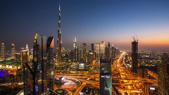 Day to Night Timelapse of Dubai City Center with Modern Tall Skyscrapers and Busy Street Traffic on