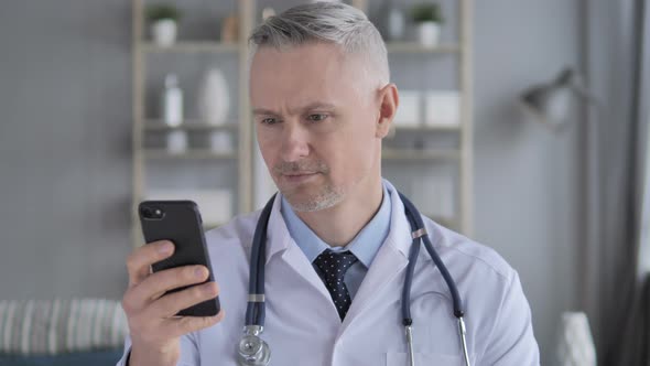 Senior Doctor Browsing on Smart Phone