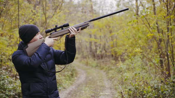 Hunter aiming for wildlife. Close up of hunter aiming down his rifle in autumn season