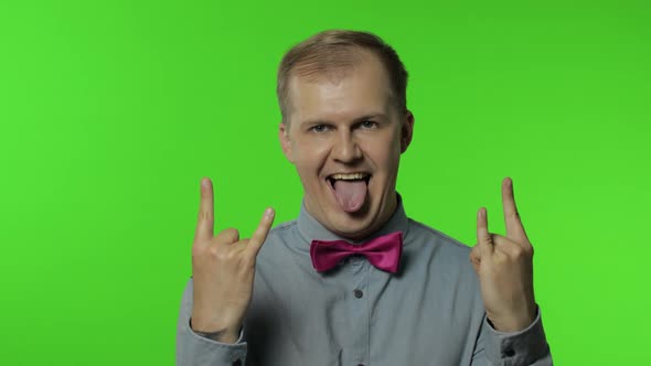 Man Demonstrating Tongue Out, Rock and Roll Hand Gesture, Punk Sign, Excited By Win, Crazy Success