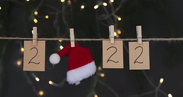 Happy New Year 2022 Background with Numbers and Red Santa Hat