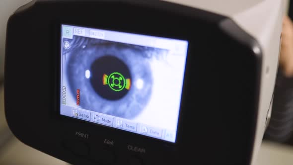 Young Optometrist Checks Kid's Vision Using Autorefractor