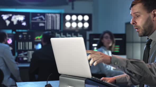 Stock Market Female Trader Working Together with Coworker with Laptop Computer in the Office