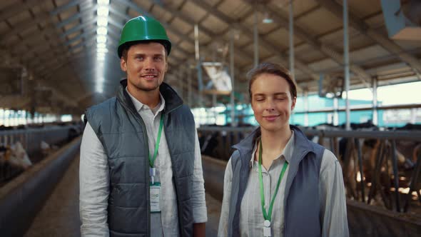 Portrait Livestock Team Posing Together Modern Cowshed at Dairy Farm Facility