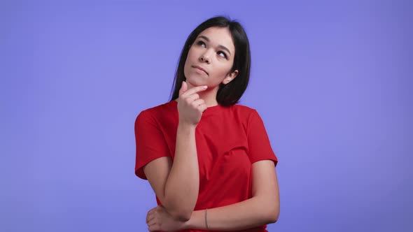 Portrait of Woman Having Idea Moment Pointing Finger Up on Violet Studio Background