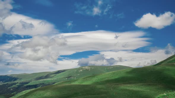 Top View of the Beautiful Wide Hills of the Mountain, Covered with Grass Under Layers of Cirrus