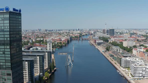 Forwards Descending Fly Above Spree River Towards Molecule Man Tall Sculpture