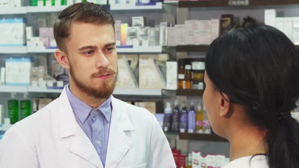 The Pharmacist Listens Attentively To His Client