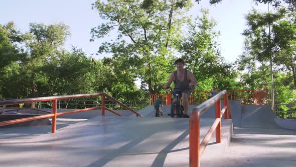 BMX Rider Doing Tricks in Cocncrete Skatepark Super Slow Motion