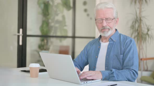 Senior Old Man Showing No Gesture By Head Shake While Using Laptop