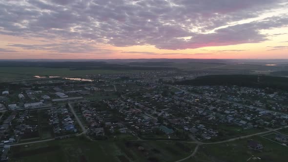 Aerial view of evening summer village at sunset 13