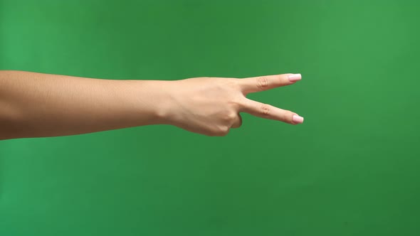 Woman's Hand Is Show Two Fingers Up On Green Screen Background. Finger Victory Symbol