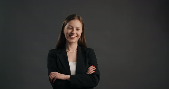 European Business Woman in Black Suit Watches to the Camera and Smiles  Prores HQ