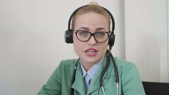 Female Doctor Using Headset and Having Conversation with Patient